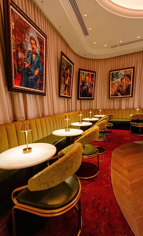 Elegant lounge interior with framed artwork, cozy seating, and ambient lighting perfect for upscale social gatherings or private events.